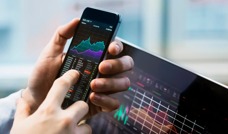 BrainChip (BRN) stock forecast Businessman holding a phone