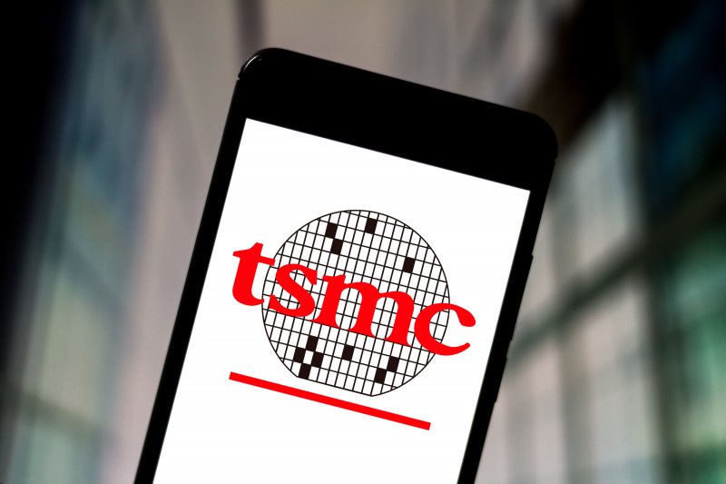 Taiwan Semiconductor (TSM) stock forecast In this photo illustration the Taiwan Semiconductor Manufacturing Company (TSMC) logo is displayed on a smartphone.