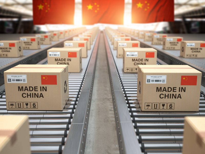 China interest rate forecast for next 5 years Cardboard boxes with Chinese-made text and a Chinese flag on a roller conveyor.