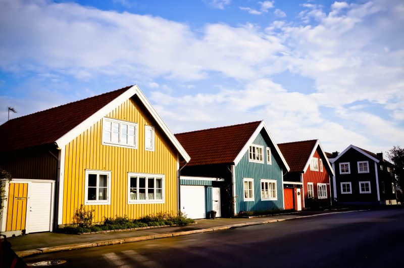 Sweden housing market crash Picture of a swedish street with small multi coloured houses during spring