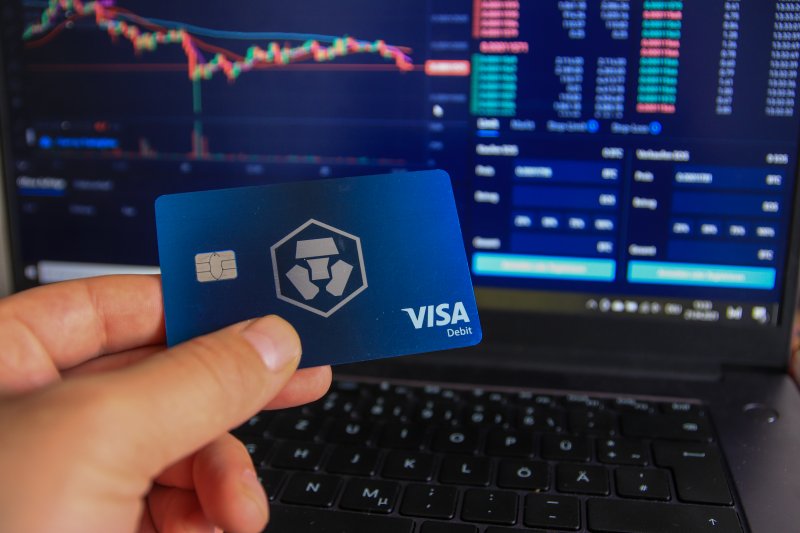 Crypto.com VISA card Man holding Crypto.com debit card in hand