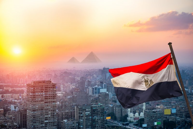 Egypt interest rate forecast in 5 years View of evening Cairo from above and egyptian flag