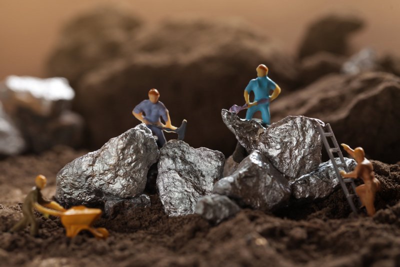 Lithium price forecast: Rising EV demand to cause new highs? Mining of Tantalum, Nickel, Cobalt, lithium. Miniature worker mining metal Tantalum and silver. Mining business, Mineral Resources.