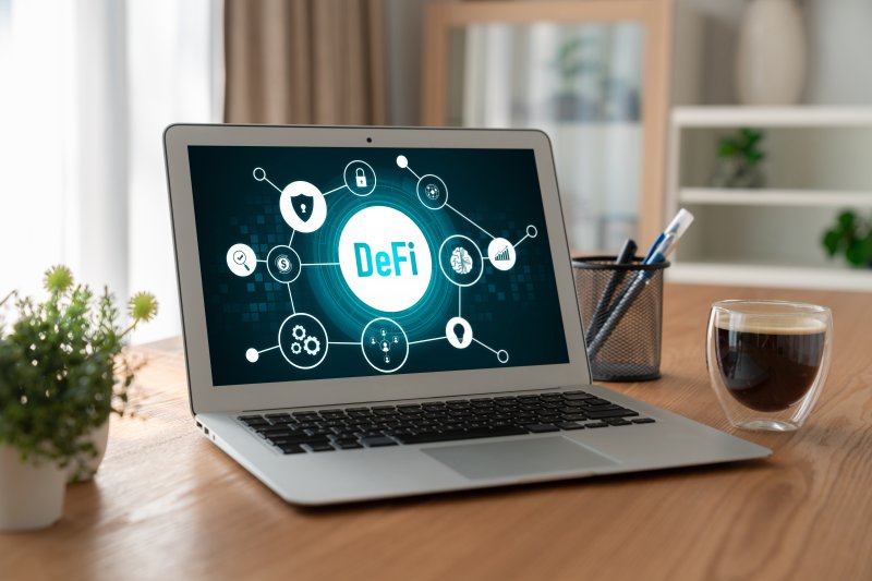 VVS Finance A laptop features an illustration explaining decentralised finance (DeFI)