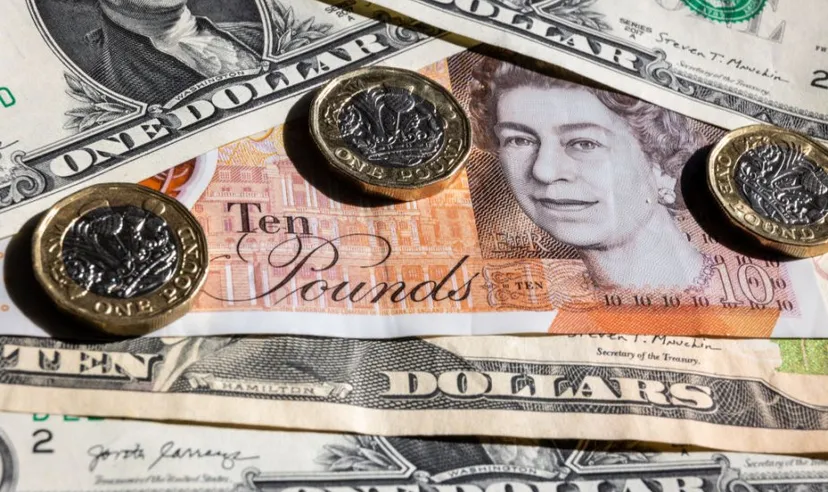 US dollar bills with British £1 coins and notes
