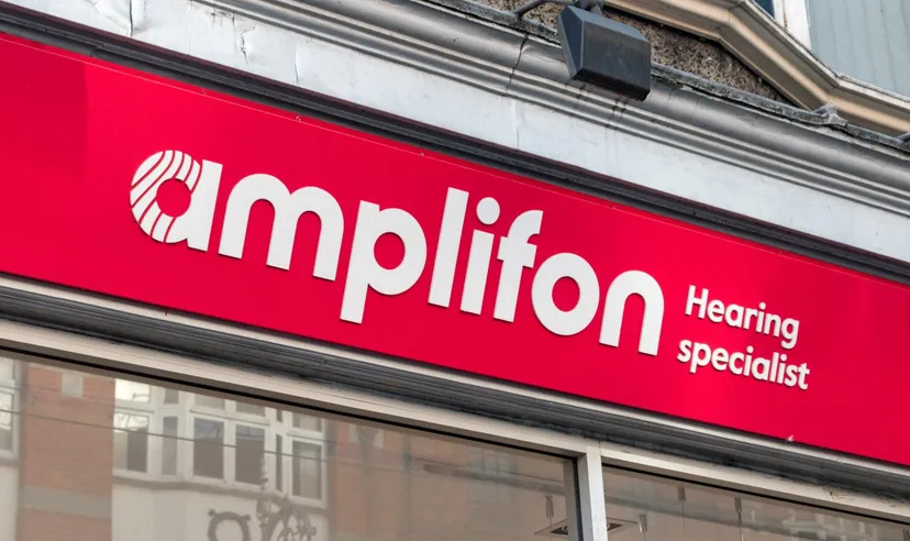 Amplifon logo on a retail storefront, representing the global hearing care and hearing aid provider.