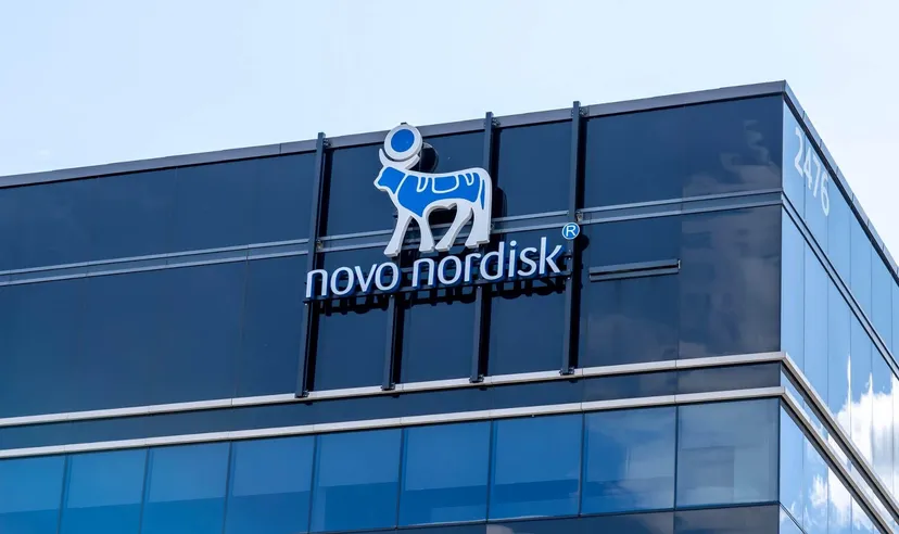 Novo Nordisk logo displayed on the glass façade of a modern office building, representing the global pharmaceutical and healthcare company.