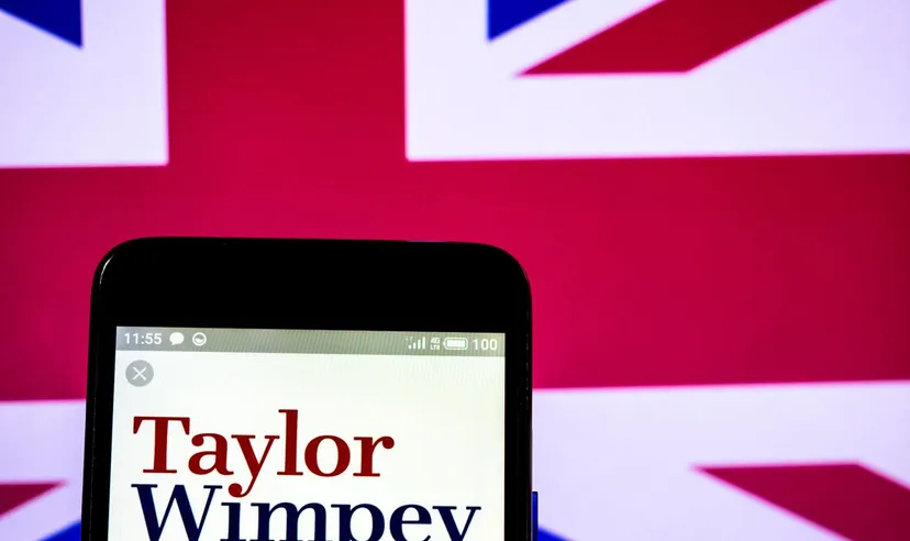 Smartphone displaying the Taylor Wimpey logo against a Union Jack background, representing the British housebuilding company.
