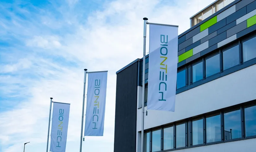 BioNTech flags displayed outside a modern office building BioNTech flags displayed outside a modern office building