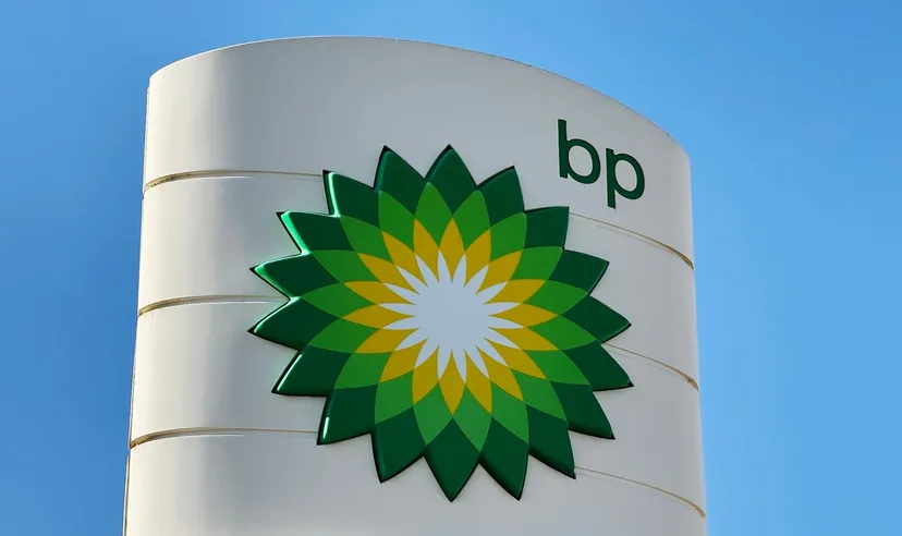 BP logo displayed on a white cylindrical sign against a clear blue sky