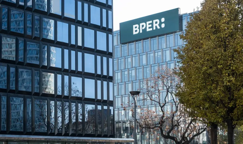 BPER logo displayed on the rooftop of a modern office building with glass facades. BPER logo displayed on the rooftop of a modern office building with glass facades.