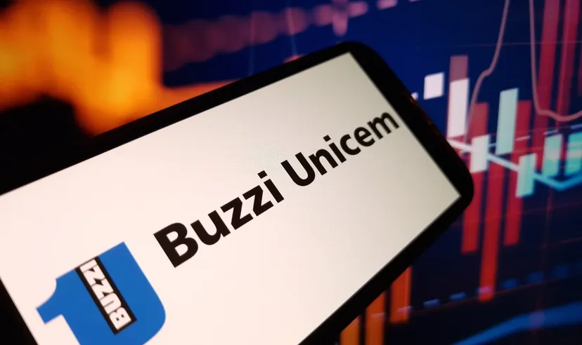 Buzzi Unicem logo on a mobile device with financial charts, representing the cement and construction materials company in the stock market context
