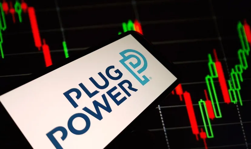 Plug Power logo displayed on a smartphone screen with a stock market candlestick chart in the background