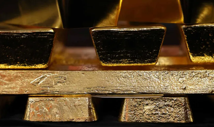 Close-up of stacked gold bullion bars with reflective metallic surfaces