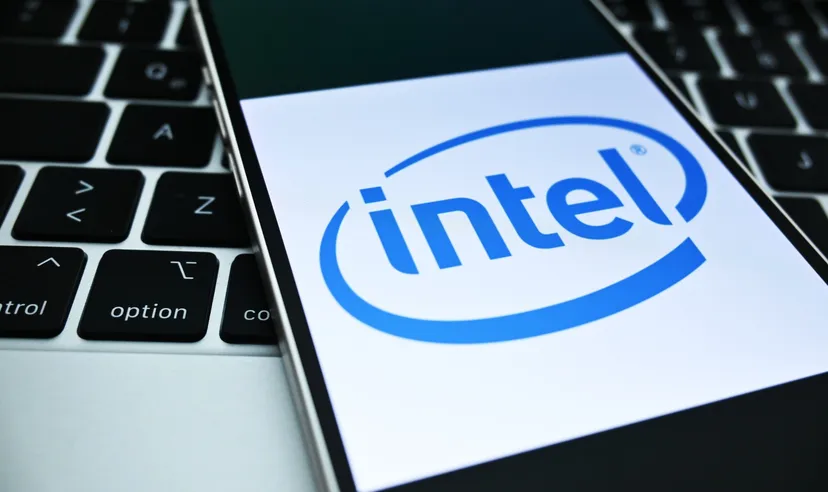 Smartphone displaying Intel logo placed on a laptop keyboard