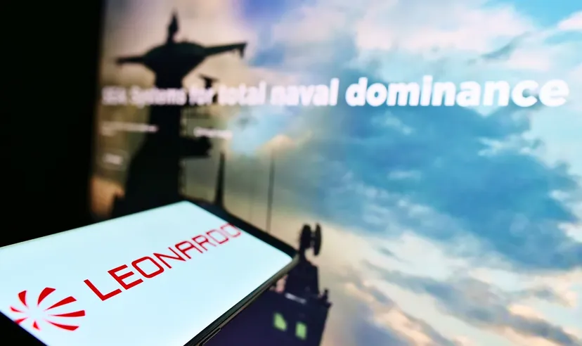 Smartphone displaying Leonardo company logo with blurred defense-themed background on a screen
