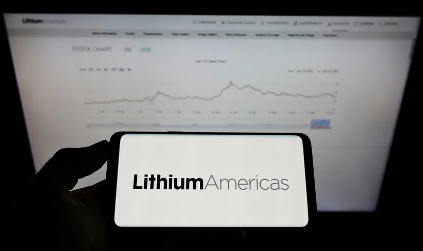Person holding mobile phone with logo of Canadian company Lithium Americas Corp. on screen in front of business web page. Focus on phone display. Unmodified photo.