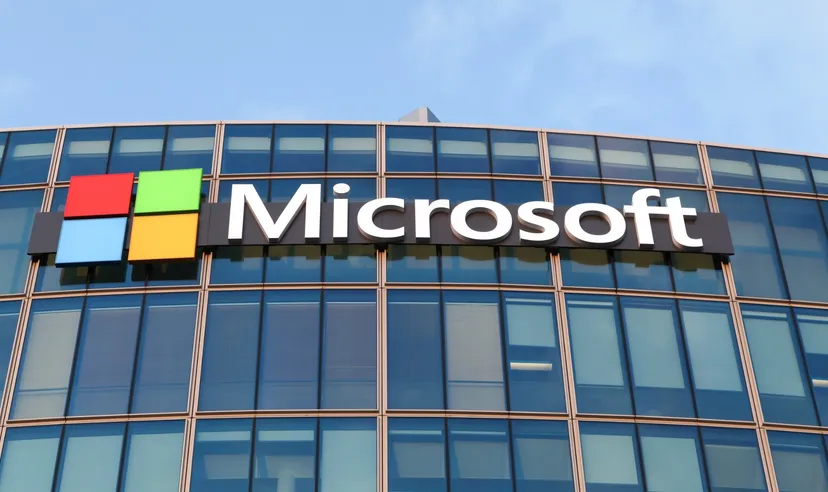 Microsoft logo displayed on the glass facade of a modern office building