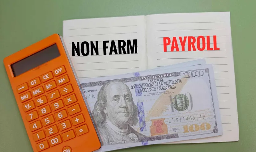 Non-Farm Payroll notebook with calculator and US dollar Notebook displaying the words