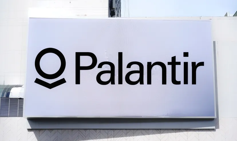 Palantir logo displayed on a large white sign on a building exterior.