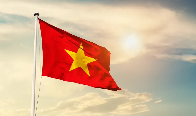 how to invest in vietnam stock market Vietnam national flag cloth fabric waving on the sky with beautiful sun light - Image