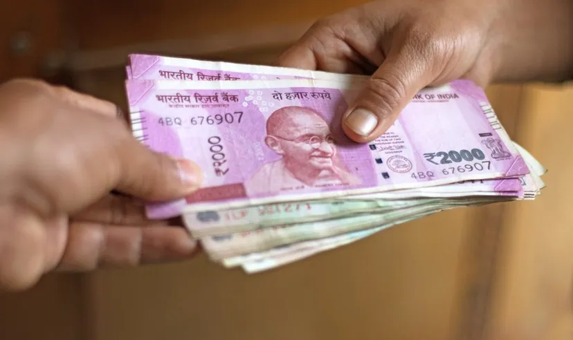 Stack of Indian rupees Small stack of Indian rupee notes changing hands