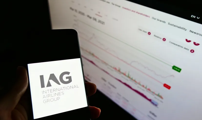 Stuttgart, Germany - 03-10-2021: Person holding smartphone with logo of airline company International Airlines Group (IAG) on screen in front of website. Focus on phone display. Unmodified photo.