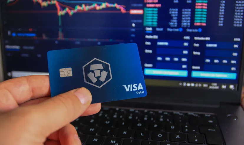 Man holding Crypto.com debit card in hand