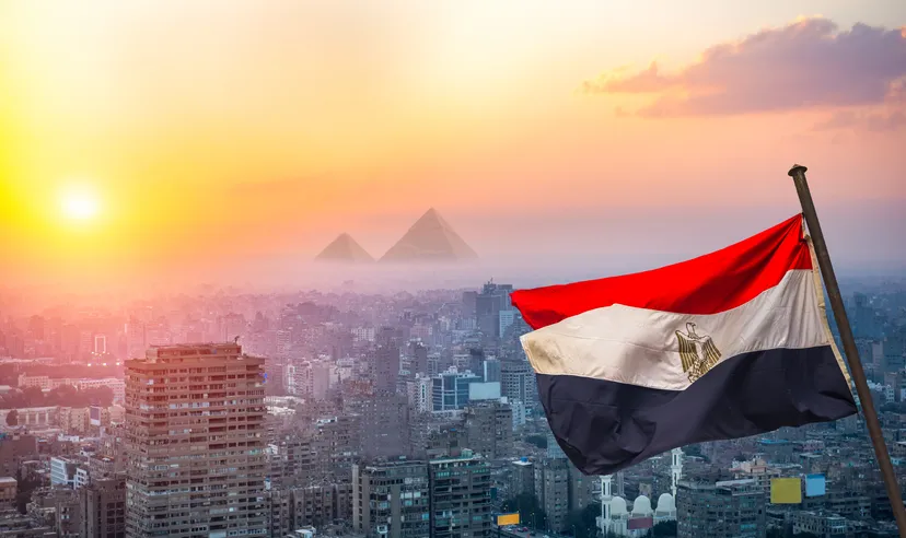 View of evening Cairo from above and egyptian flag