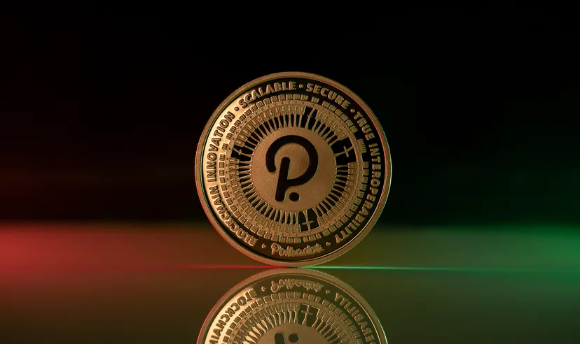 Polkadot DOT cryptocurrency physical coin placed on reflective surface and lit with green and red lights
