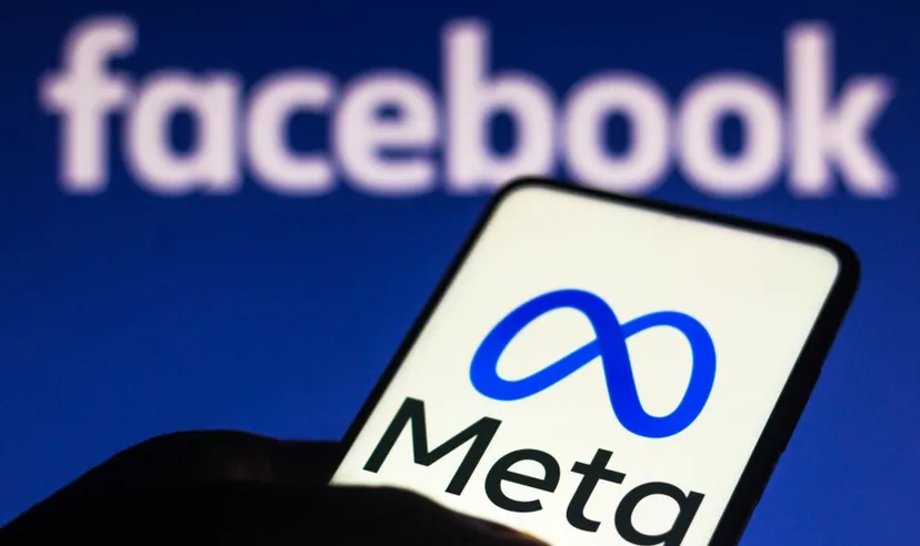 Meta logo on a mobile screen with a Facebook background