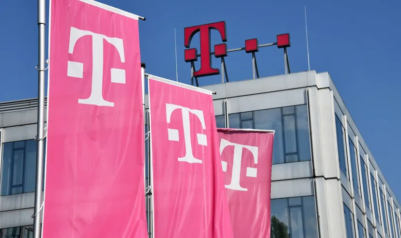 Deutsche Telekom flags and logo displayed on a modern office building exterio
