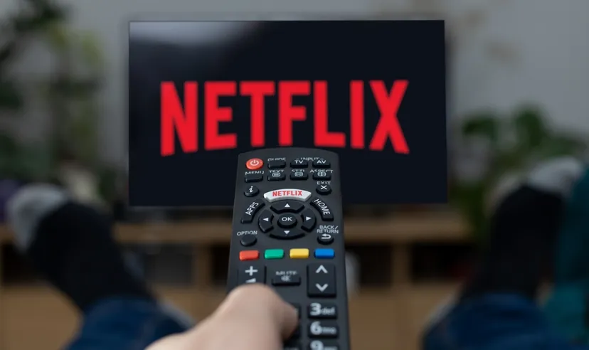 TV Television Netflix logo on screen with remote control in home.