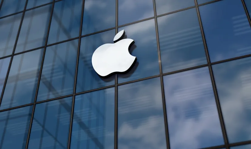 Apple logo displayed on the glass exterior of a corporate office building.