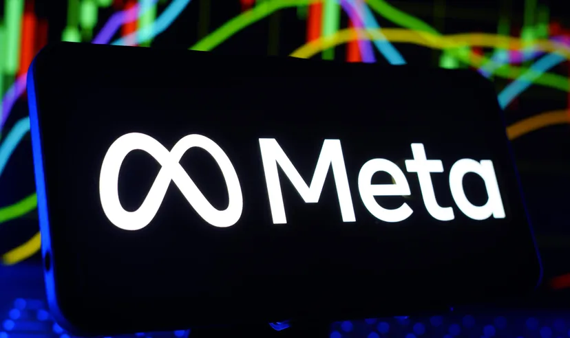 Meta logo displayed on a smartphone screen with a colourful financial market chart in the background.