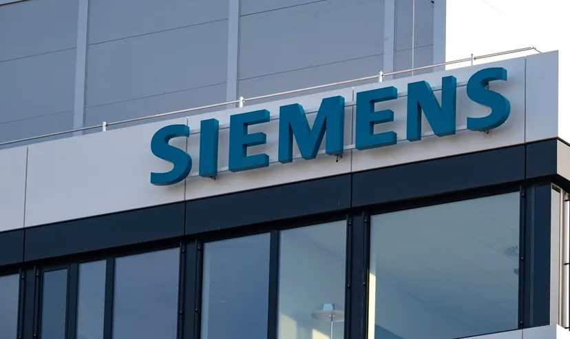 Siemens logo on the exterior of a modern office building with glass windows
