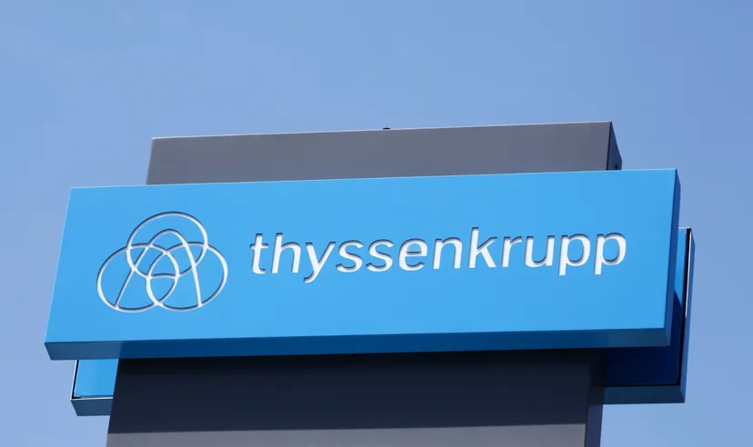 Thyssenkrupp logo on a blue sign against a clear sky
