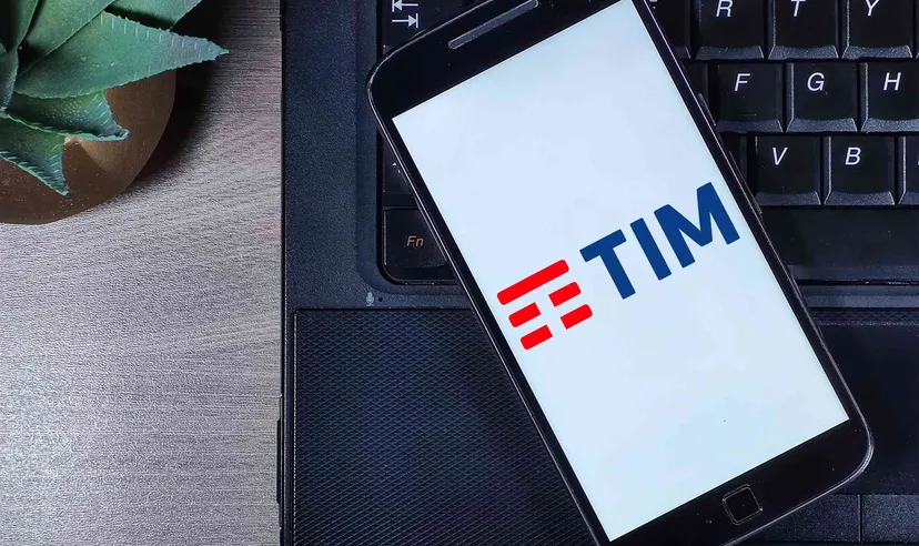 Smartphone displaying TIM logo placed on a laptop keyboard