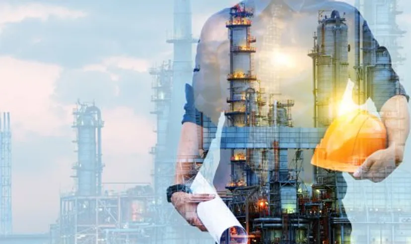 Woodside Energy stock forecast engineer in a protective helmet with a background of an oil refining plant