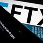 A series of smartphones display the FTX logo and mobile app adverts
