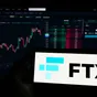 The FTX logo and name is displayed on a mobile phone