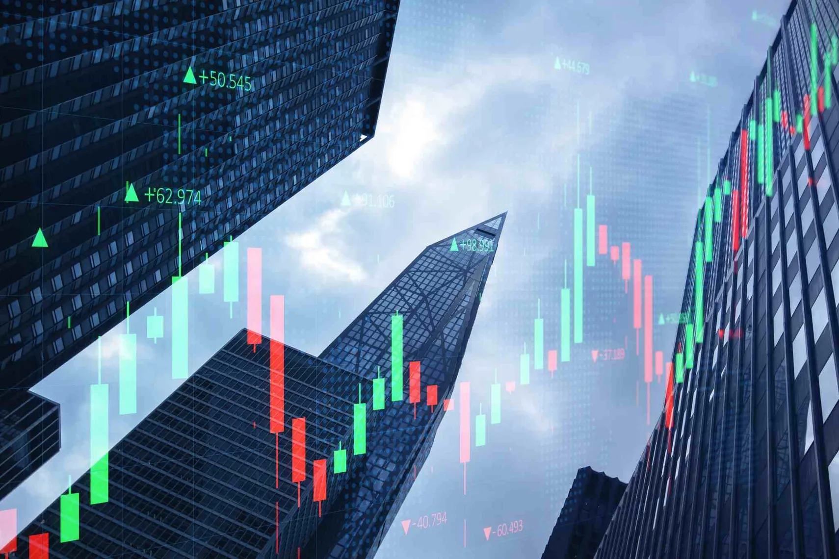 Stock market chart over financial district skyline (Source: Shutterstock) Candlestick stock market chart overlaid on modern office buildings, illustrating financial markets, trading activity, and investment performance.