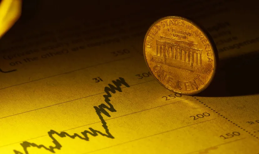 US one-cent coin on financial chart (Source: Shutterstock)