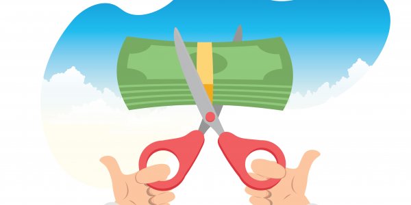 split payroll definition a stack of money is inserted into scissors